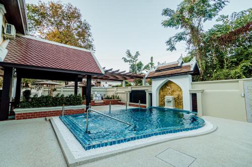 a swimming pool in the backyard of a house at Lux Hotel in Luang Prabang