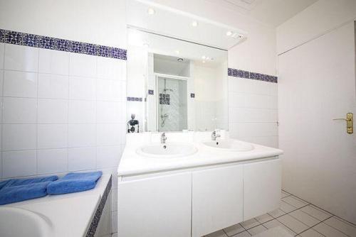 a bathroom with a sink and a toilet and a mirror at Villa House With Panoramic View On Paris in Suresnes