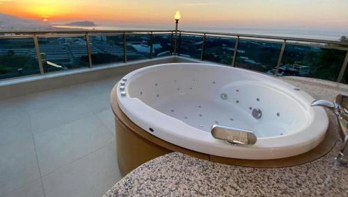 a bath tub on a balcony with a view of the ocean at Villa Oliena Sahil in Istanbul