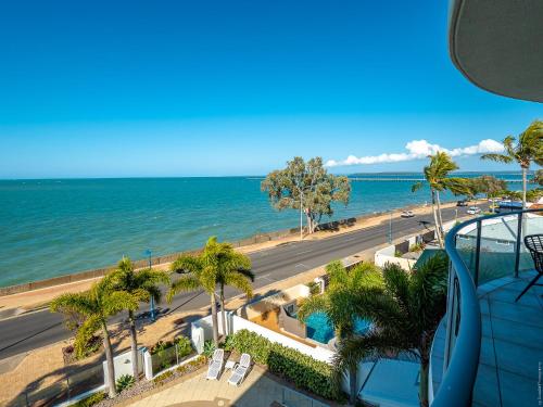 a view of a beach and the ocean from a building at Pier View Serenity in Urangan