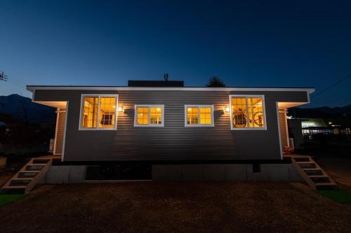 a house with its lights on at night at 赤だすき_別邸 in Hakuba