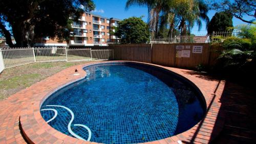 a swimming pool in a yard with a building at Heritage 302 in Tuncurry
