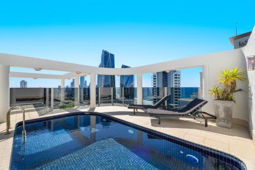 a swimming pool on the roof of a building at Biarritz Apartments in Gold Coast