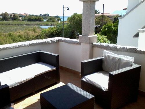 a balcony with two chairs and a table at Relax al Mare in Olbia