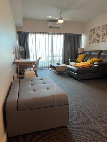 a large living room with a couch and a bed at Pandanas Apt 1 (U will love it) in Darwin