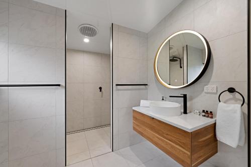 a bathroom with a sink and a mirror at Highview Atherton in Atherton