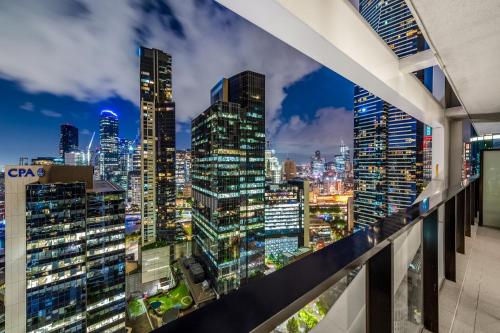 a view of a city skyline at night from a balcony at Exclusive Stays - Wrap in Melbourne
