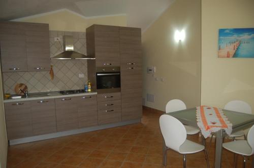 a kitchen with a table and chairs in a room at Relax al Mare in Olbia