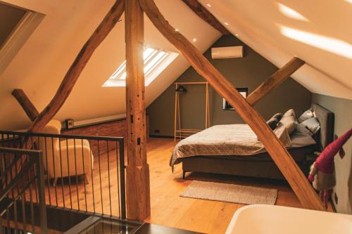 a bedroom with a bed in a attic at Gîtes de la Chapelle in Assesse