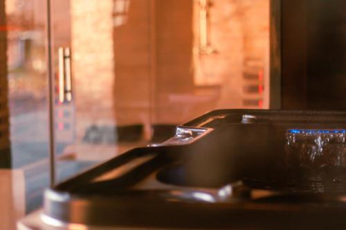 fregadero negro en una cocina con ventana en Gîtes de la Chapelle en Assesse