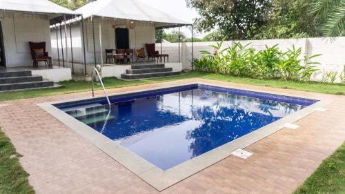 a swimming pool in the yard of a house at 16 Bedouin Private Pool Villa in Hosūr