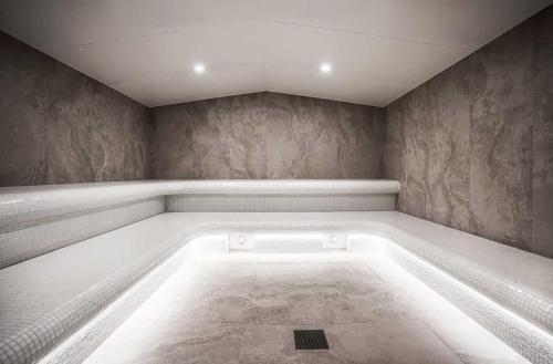 a room with a bath tub in the corner at Rest Skygarden Collection in Glen Waverley