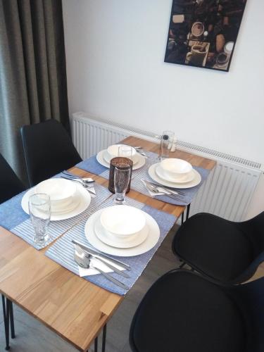 a wooden table with plates and silverware on it at Danifeld Inn in Voronet