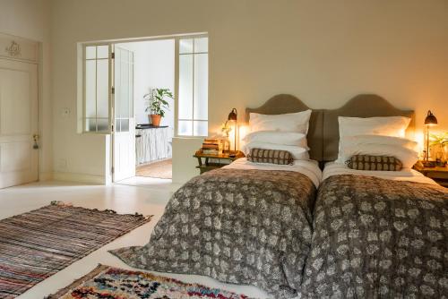 a bedroom with a large bed with a large blanket at Dorp Hotel in Cape Town