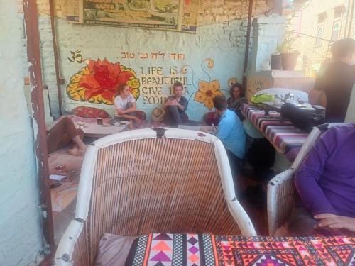 a group of people sitting in a room with beds at Shiva Guest House in Jaisalmer