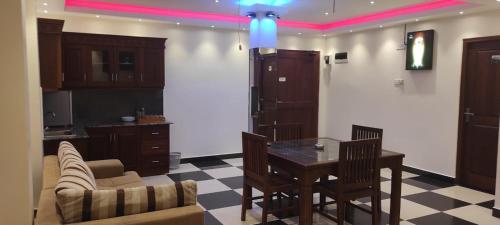 a living room with a table and a couch at Grand Rovinka Hotel in Dehiwala