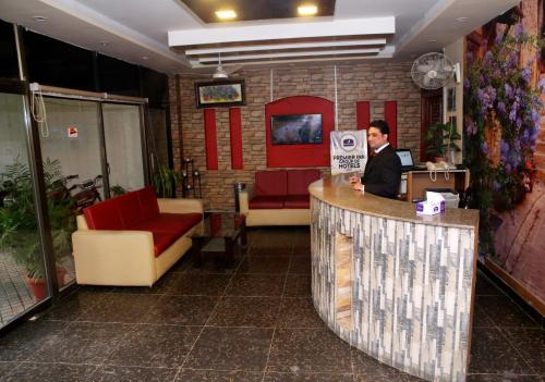 a man standing at a counter in a restaurant at Premier inn Mall Lahore in Lahore