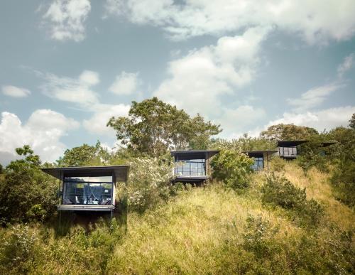 a house on top of a hill with trees at Santani Wellness Kandy in Kandy