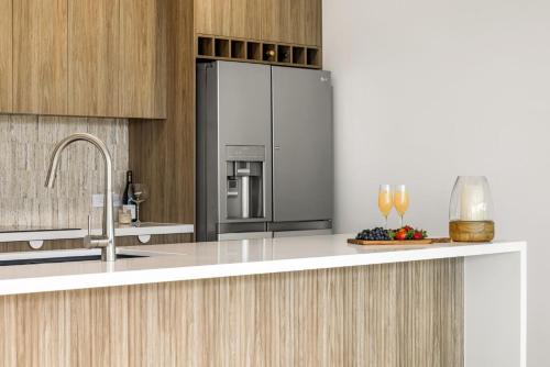 a kitchen with a stainless steel refrigerator and a counter at Coorumbong 16 - 5 bedrooms in Mooloolaba