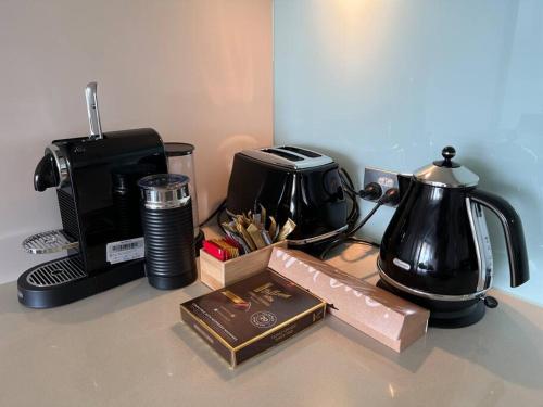 a counter top with a coffee maker and a toaster at Luxury Waterfront Stay 1bdr (breathtaking Views) in Darwin