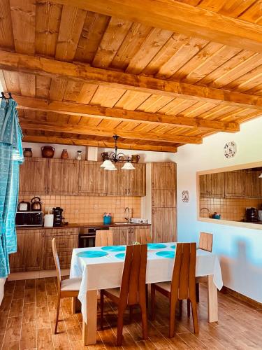 a dining room with a table and chairs in a kitchen at Csigevár Birtok in Balatonendréd
