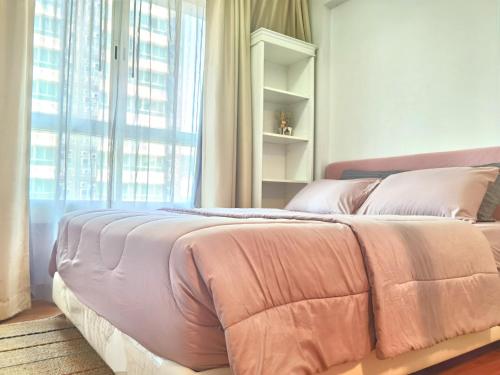 a bed in a room with a large window at Rama9 Cozy Apartment in Bangkok