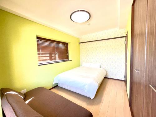 Una cama o camas en una habitación de Luana Uakoko Resort 旧 EmiFull Resort