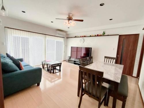 a living room with a couch and a table at Luana Uakoko Resort 旧 EmiFull Resort in Chatan