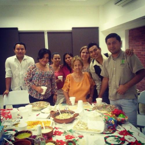 a group of people standing around a table at Hotel & Suites Mo Sak in Tapachula