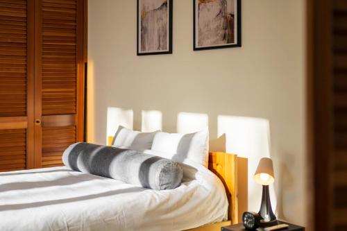 a bedroom with a bed with white sheets and pillows at Suite Villa Nasukogen Terrace in Nasu
