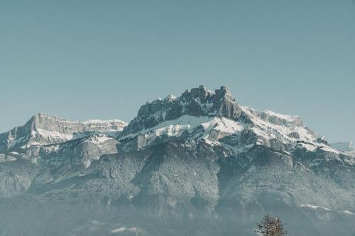 a mountain with snow on top of it at Hôtel Les Roches Fleuries in Cordon