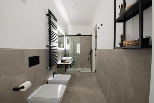 a bathroom with two sinks and a toilet and a shower at LA CASA DI SAM in Amalfi