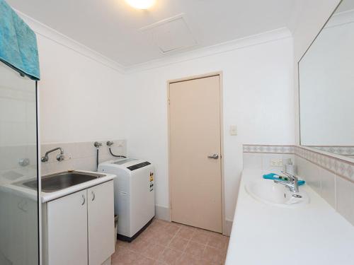 a small white bathroom with a sink and a sink at Duke's Apartments in Perth