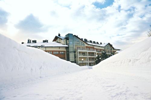 a pile of snow in front of a building at Hotel Activa in Muszyna