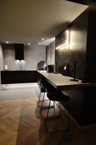 a kitchen with a counter and a table and chairs at Fiorini Rooms Sora in Sora