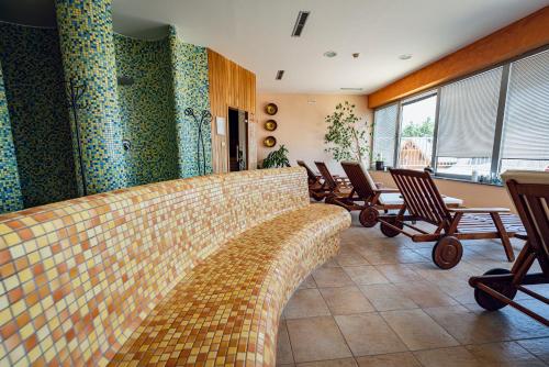 a living room with a couch and chairs at Pohorje Village Wellbeing Resort - Family Apartments Bolfenk in Pohorje