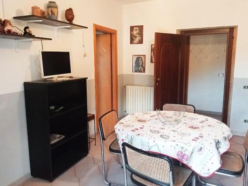 a dining room with a table with chairs and a television at bed and breakfast- Ai piedi del parco in San Donato Val di Comino