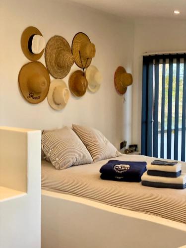 a bedroom with a bed with hats on the wall at Marti Watersports in Martinchel