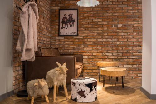 a living room with stuffed animals and a brick wall at Rezerwat Ustrzyki Górne in Ustrzyki Górne