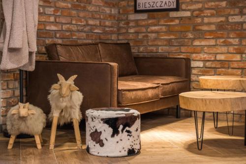 a living room with stuffed animals and a couch at Rezerwat Ustrzyki Górne in Ustrzyki Górne
