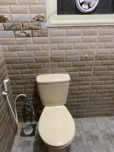 a bathroom with a white toilet in a room at Family Condo With Panoramic Sea View 1 in Alexandria