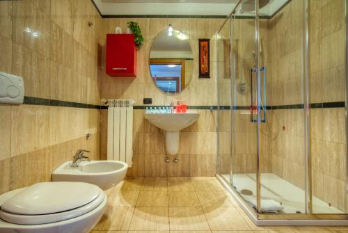 a bathroom with a toilet and a sink and a shower at Italianflat - Il Giardino del naviglio Terrace in Milan