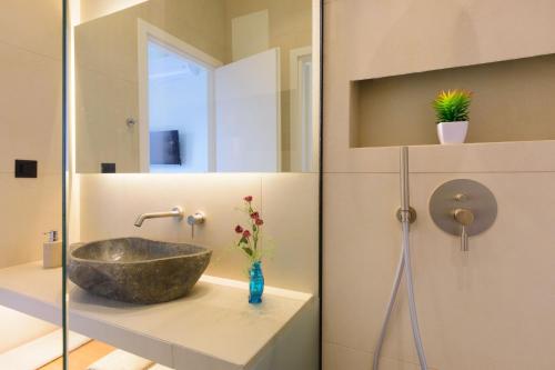 a bathroom with a stone sink and a mirror at Majestic View Villas in Agios Nikolaos