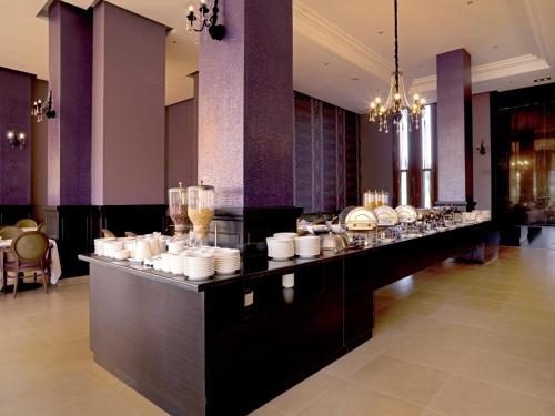 a buffet line with plates and glasses on it at Palais Medina Riad Resort in Fès