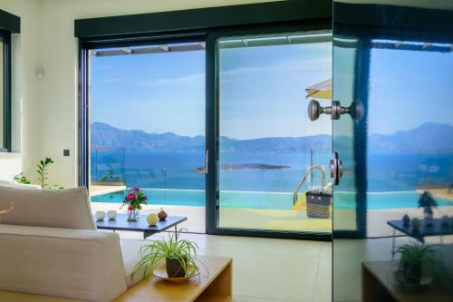 a living room with a view of the water at Majestic View Villas in Agios Nikolaos