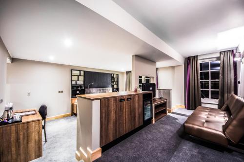 a living room with a couch and a table at Courthouse Hotel London in London