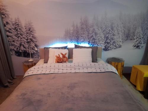 a bedroom with a bed with two dogs sitting on it at Sibirska Central in Kolašin