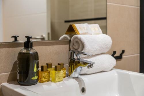 a bathroom sink with a bottle of soap and towels at VACATION MARBELLA I Via Celere, Huge Terrace, Brand New Complex, Close to the Beach, Marbella Center in Marbella