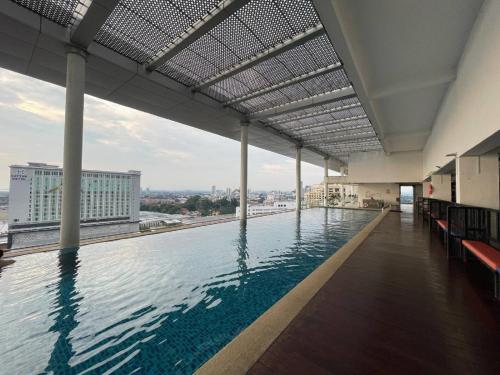 a swimming pool on the roof of a building at Melaka The Straits Residence in Malacca