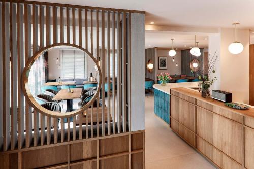 a kitchen and living room with a large mirror at Hotel Astra Maris in Büsum